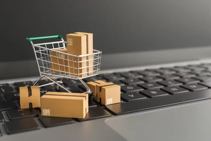 A miniature trolley and parcels resting on a keyboard