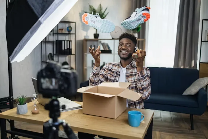 A seller filming himself unboxing at a desk
