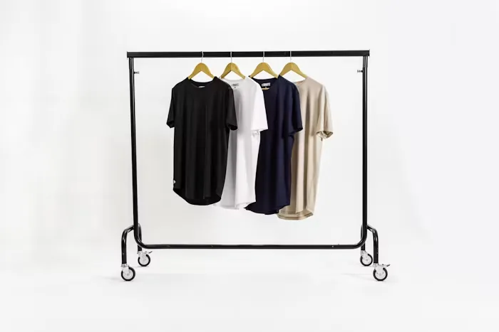 A clothing rail against a plain wall